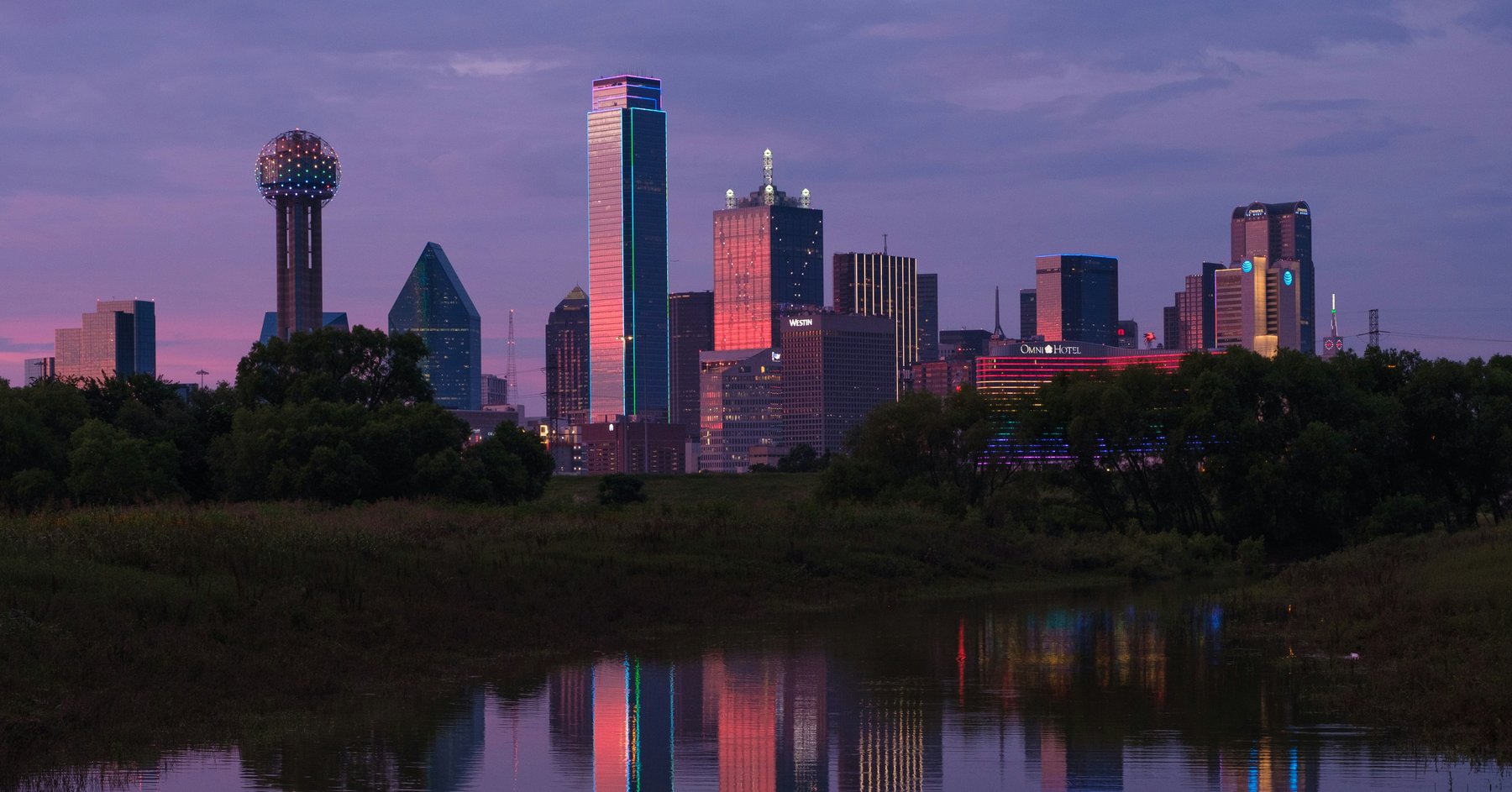 The Dallas skyline at dusk &mdash; the business community this firm serves.